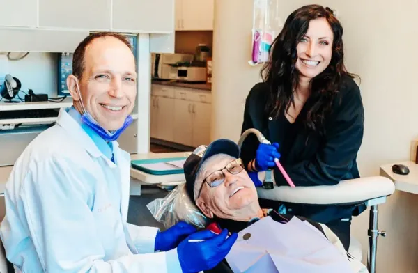 Dr. Gailey and a team member with a patient at Gateway Family Dentistry